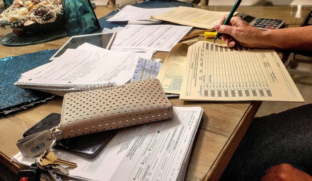 Retired senior woman at her desktop working on her federal taxes because no state taxes in Florida.